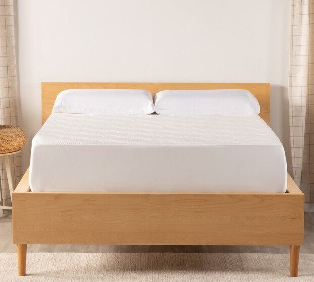 Sleepy's cooling knit protector on a mattress in a wood frame.