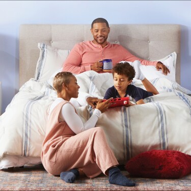A family enjoying time together around a bed