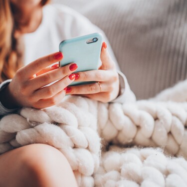 millennial on phone in bed