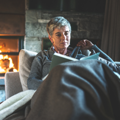 woman reading a book on the couch