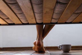 feet next to a slatted bed