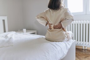 woman with back pain in bed