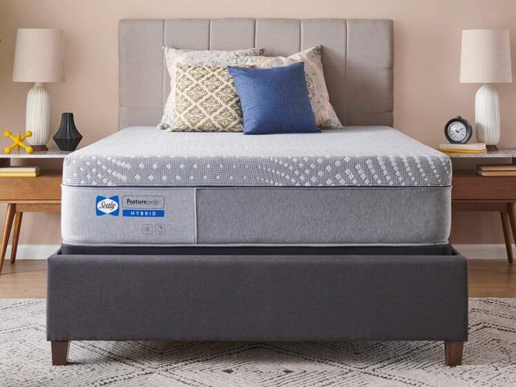 sealy posturepedic hybrid norman medium mattress on bed frame